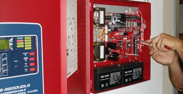 fire alarm installation service showing technician configuring fire alarm control panel in Lakeland, FL