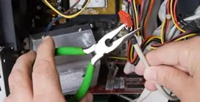 Licensed electrical contractor performing electrical repair with tools in Winter Haven, FL