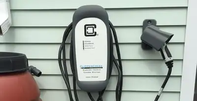 Outdoor electric vehicle charger installation on residential wall in Lakeland, FL