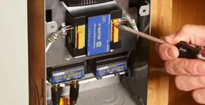 Whole home surge protection device being installed by a licensed electrician to protect electrical systems in Lakeland, FL